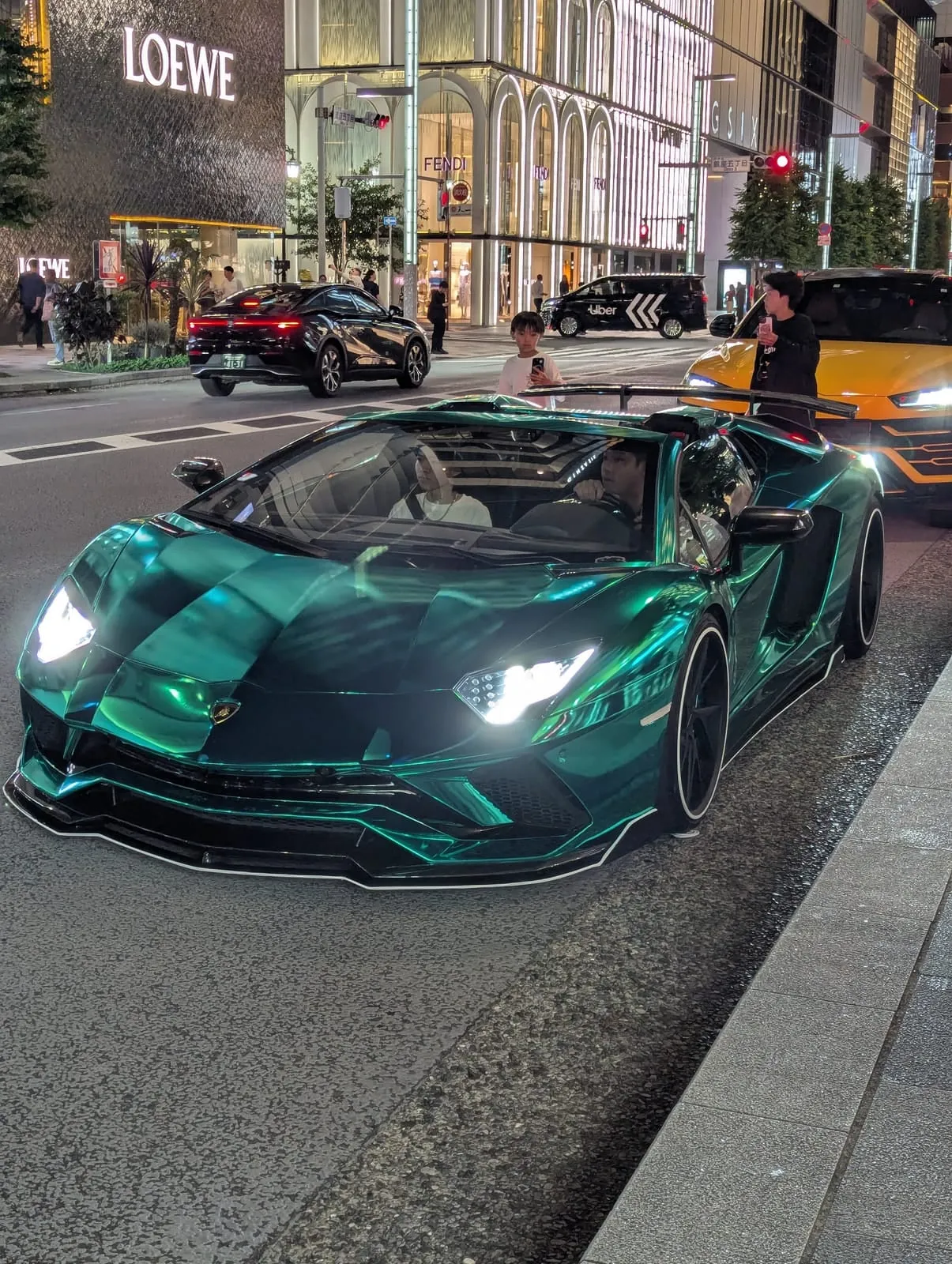 Sports cars outside Ginza Six at night
